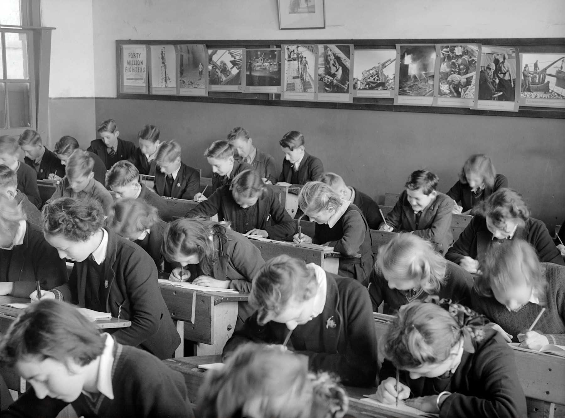 Interior of a classroom, students bent at study, Yallourn, 1947.